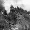 Doubleheaded ten-wheelers work hard as they lift train N. 15 up the Siskiyou grade in 1912.  Crossing the Wall Creek Viaduct the train has just traversed the track visible down the hillside to the right.
Interstate Hwy 5 now runs just above the tracks below.